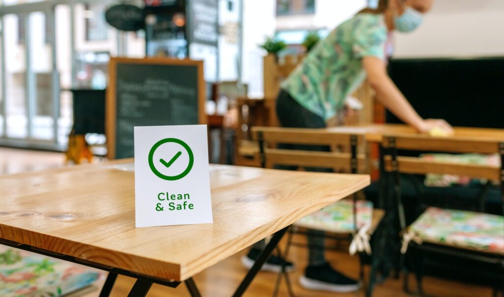 Clean and Safe sign placed on a table