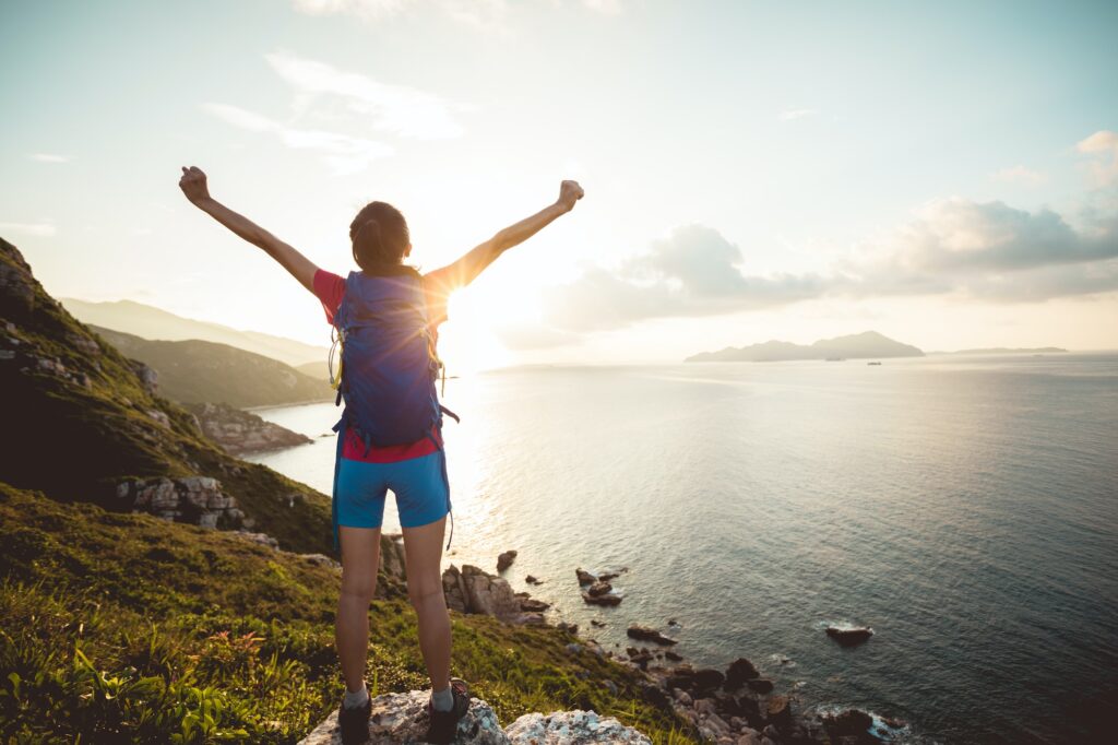 Woman feel strong face the sunrising at the sea level